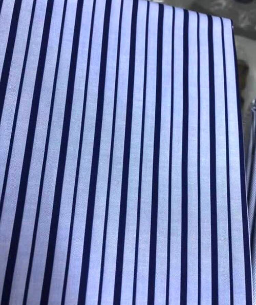 A close-up of a striped pattern on a shirt made of Italian poplin cotton.